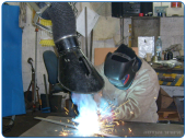 Suction arm for drawing dangerous welding smoke and maintaining employee health